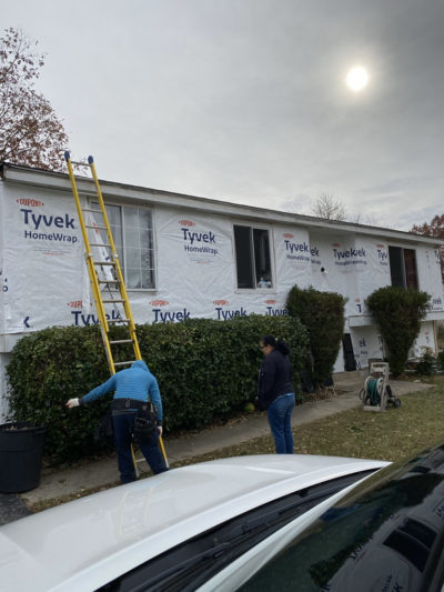 Contractors working on the side of house