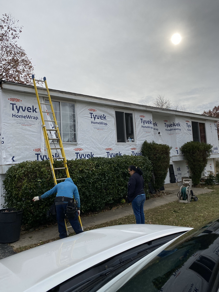 Contractors working on the side of house