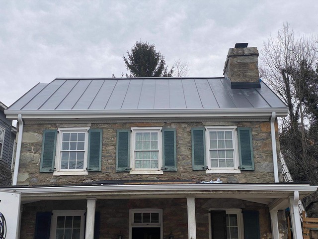 Front view of house with silver-colored metal roofing