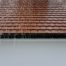 Rain water flowing off of a brown roof top