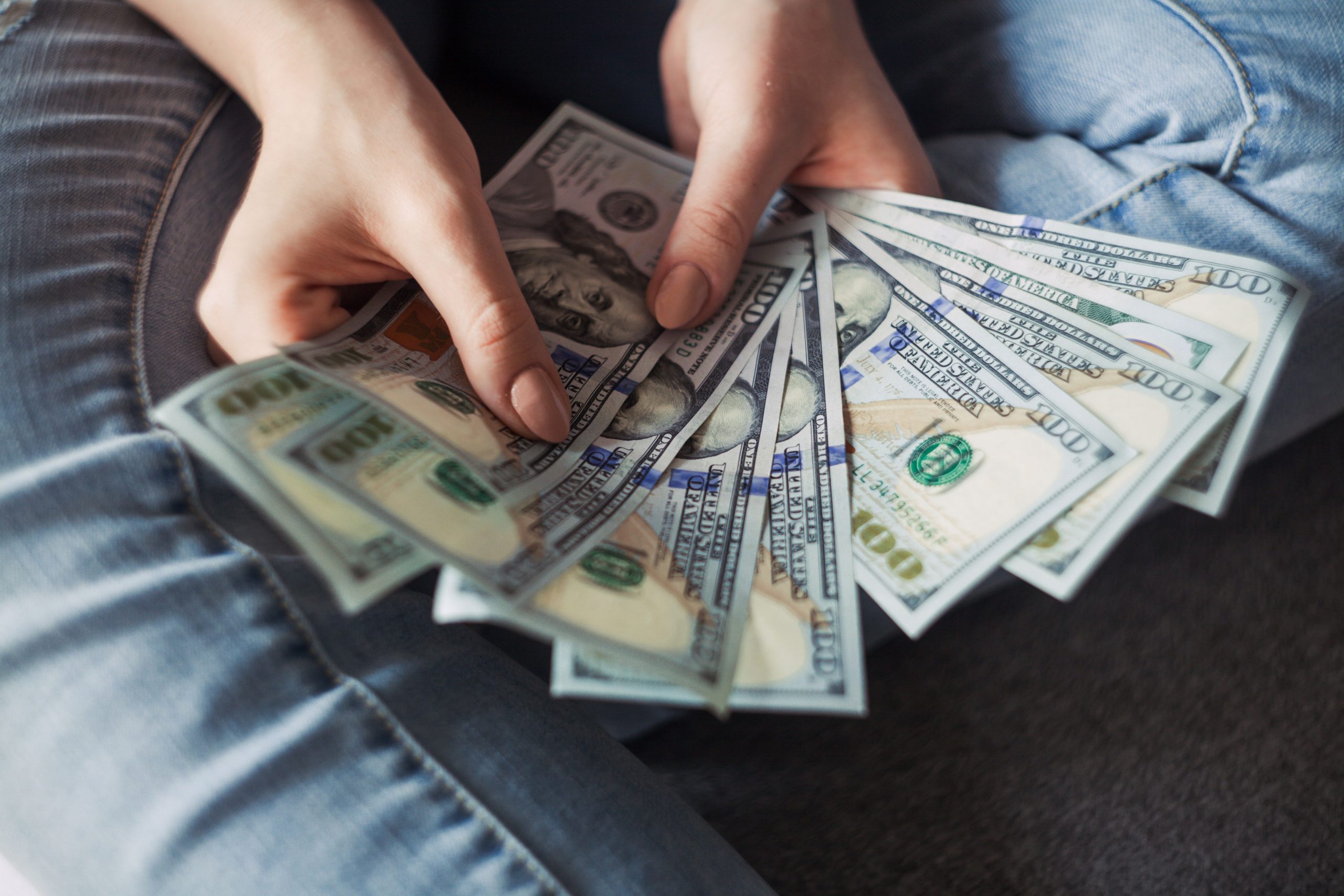 blog_cost_img Person holding hundred dollar bills